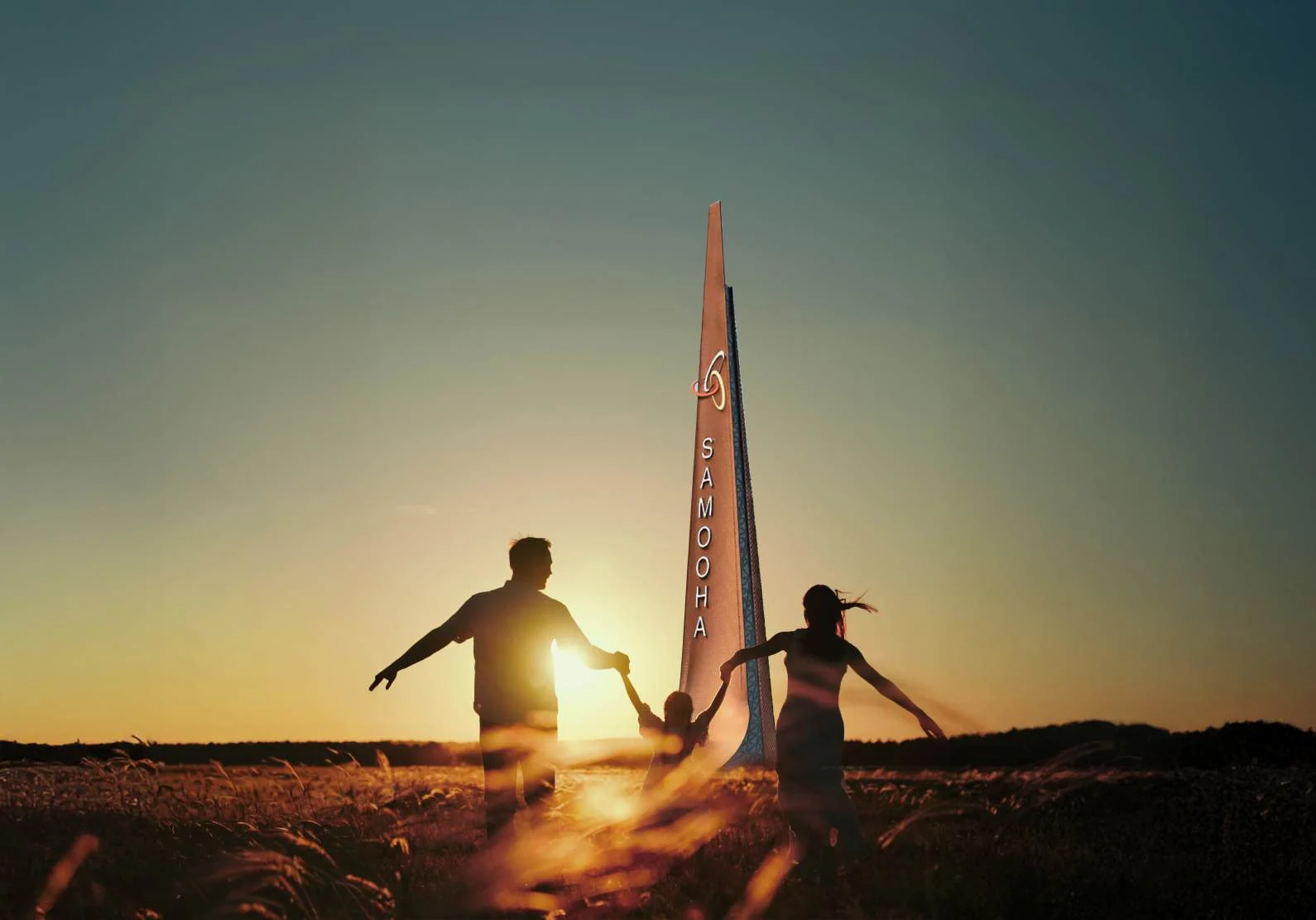 A family spending time together in the open landscape at sunset
